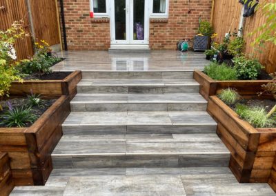 Porcelain steps oak sleepers terraced garden