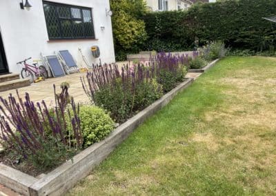 New raised beds enclosed the patio and plants adding colour