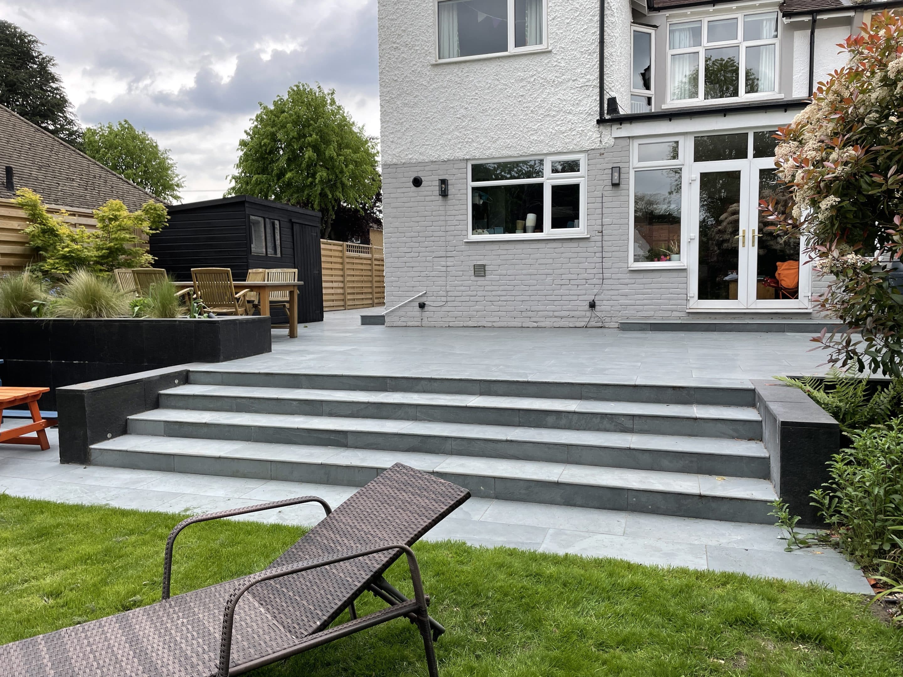 Steps and patio area opened up the entertainment area in front of the house.