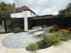 The effect of black fences and trellis The black fencing and trellis makes these landscape items less if a feature and they allow the colours of the plants to pop.