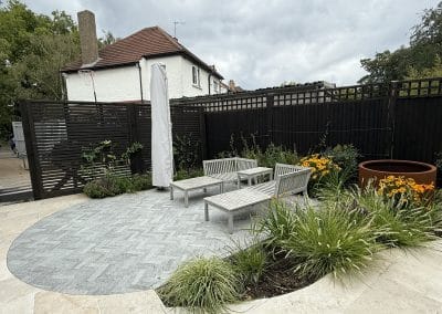 The black fencing and trellis makes these landscape items less if a feature and they allow the colours of the plants to pop.