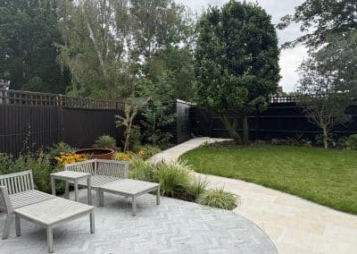 An elegant garden design creating different seating areas for both adults and teenagers.